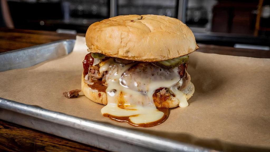Tony Montana · SLAB version of a Cuban sammich. Pulled pork topped with sausage, pickles, queso and Gold Rush sauce.
