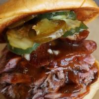 Texas Trill · Brisket, Sausage, Rib Meat, served with onions, pickles, and jalapenos & backyard red sauce