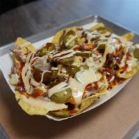 Bbq Nachos Small- Boat · Tortilla chips with your choice of BBQ meat topped with queso, onions, pickles, jalepenos an...
