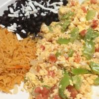 Huevos Ala Mexicana . · Scrambled eggs cooked with onion, tomatos, and bell pepper. Served with rice, beans, and tor...