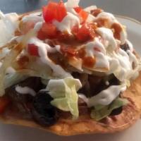 Tostada (1) · Fried corn tortilla served with your choice of meat (asada, chicken, chorizo, pastor) or veg...