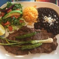 Carne Asada. · Grilled steak seved with rice, beans, salad and tortillas.