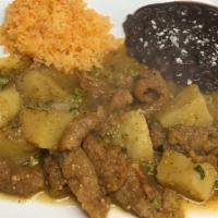 Chicharron En Salsa.  · Pork rinds and potatoes cooked in a green mild sauce, served with rice, beans and tortillas.