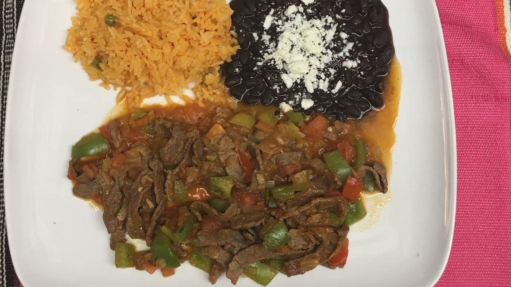 Bistec A La Mexicana.  · Sliced steak cooked with onions, tomatoes, and bell peppers served with rice, beans, and tortillas.
