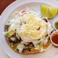 Tostadas · Meat, refried beans, cabbage avocado, tomatoes, onions sour cream and Mexican cheese.