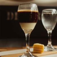 Espresso Bombon · Double shot of espresso poured over condensed milk, served with a glass of seltzer water to ...