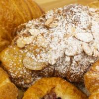 Almond Croissant · Filled with almond frangipane and topped with almond slivers & powdered sugar.