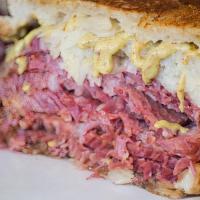 Corned Beef · stacked high with thinly cut slices of our FAMOUS Corned Beef  and served on freshly baked b...