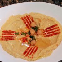 Classic Hummus · Pureed chickpeas, tahini sauce and lemon juice, topped with olive oil.