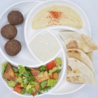 Makani Sampler · An assortment of our classic hummus, falafel, and foul mudammas, served with warm toasted pi...