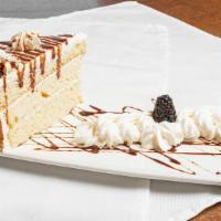 Tres Leches · House Made White Cake infused with our Signature Three Milk Mixture, Whipped Cream, Cinnamon...