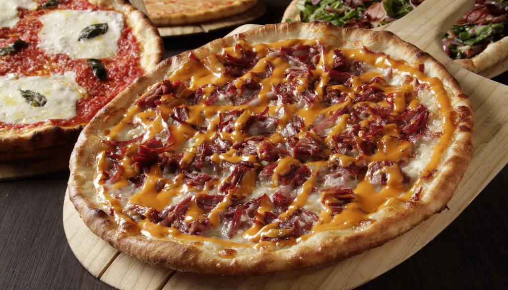 Reuben Pizza · shredded mozzarella | corned beef | swiss cheese | russian dressing