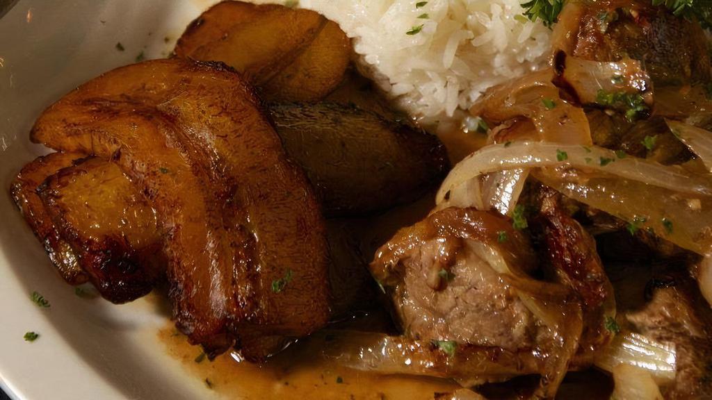 Masitas De Puerco · Morsels of gently fried pork served with rice, beans, plantains