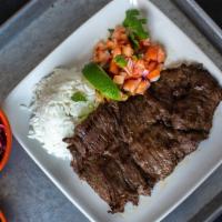 Carne Asada · Grilled skirt steak served with rice, red beans and pico de gallo.