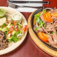 Steak Fajitas  · Sautéed with onions, tomatoes and peppers. Served with rice and beans, salad, and flour tort...