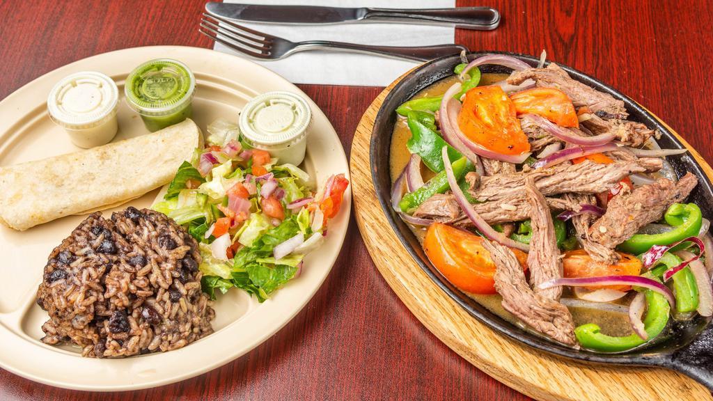 Steak Fajitas  · Sautéed with onions, tomatoes and peppers. Served with rice and beans, salad, and flour tortillas.