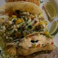 Grilled Shrimp Tacos · Two Grilled shrimp soft tacos topped with shredded lettuce, mango pico de gallo and our chip...