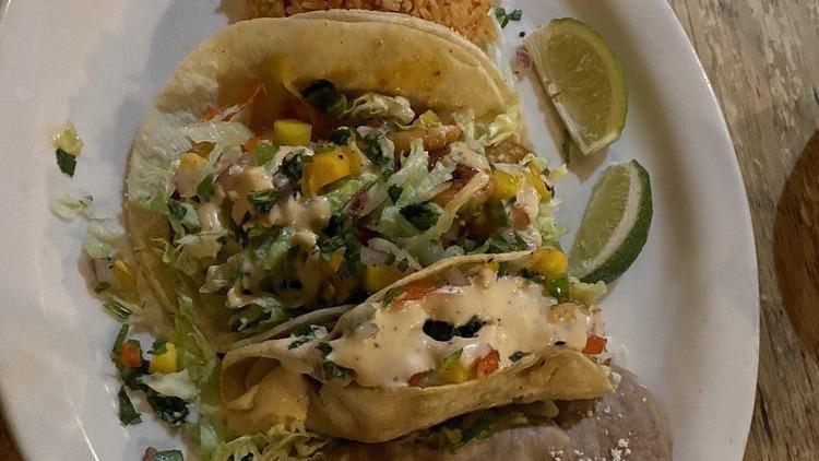 Grilled Shrimp Tacos · Two Grilled shrimp soft tacos topped with shredded lettuce, mango pico de gallo and our chipotle cream sauce.