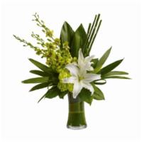 White Lilly · The graceful beauty of white lilies and opulent orchids is highlighted with an artistic, eme...