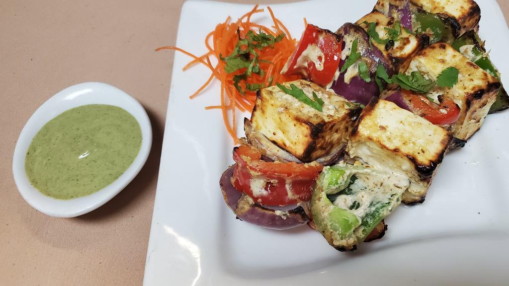 Paneer Tikka Achari · Cottage cheese slices marinated in pickled flavor, cooked in clay oven.