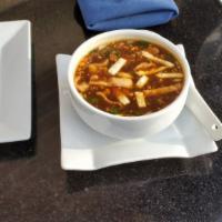 Manchow Soup · Popular Indo Chinese soup with soya base, mushroom, carrot, baby corn and basil.
