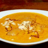 Chicken Korma  · Marinated chicken pieces in light and flavorful cashew nuts and almonds curry with tomato pa...