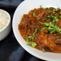 Kadhai Chicken  · Chicken curry with boneless chicken pieces served in thich gravy along with chunky pieces of...