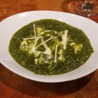 Saag Paneer  · Tempered spinach with cottage cheese cooked in spices.