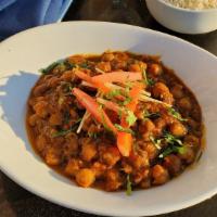 Chana Masala  · Spiced chick peas curry cooked in tomato onion sauce with chana masala.