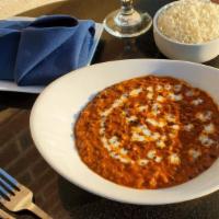 Dal Makhani · Black lentils cooked in slow fire overnight, finished with butter and tomato gravy.