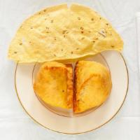 Vegetable Samosa · Two pieces. Spiced, seasoned potatoes, and peas stuffed in a pastry shell.