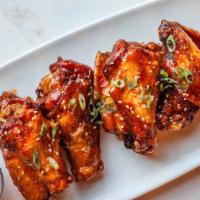 Crispy Chicken Wings · fried wings tossed in your choice of garlic honey sauce or bourbon hot sauce.