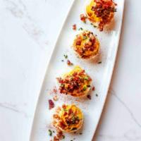 Deviled Eggs · gluten free. classic creamy deviled eggs topped with candied nueske bacon.