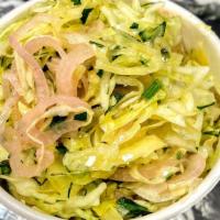 Slaw · Cabbage, pickled shallots, herbs, olive oil lemon dressing.