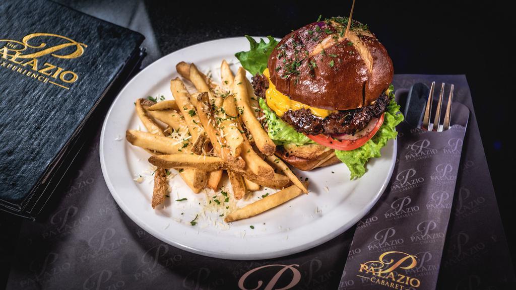 Palazio Steak Burger · 8 Oz ribeye/sirloin patty on a sesame seed bun dressed in mayo, leaf lettuce, tomato, pickle, and onion. Served with French fries.
