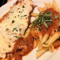 Chicken Parmigiana · Boneless breast of chicken breaded and fried, smothered in our meat sauce. Topped with mozza...