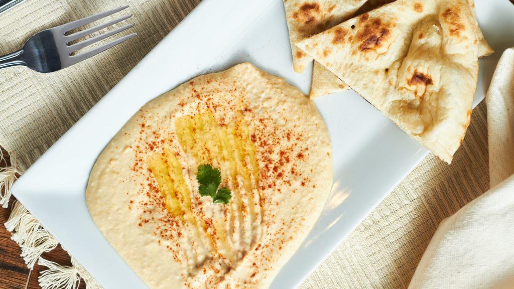 Hummus · Homemade hummus served with fresh house baked naan.