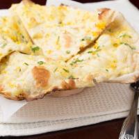 Garlic Naan · Simple but delicious unleavened flatbread with garlic cooked in clay oven.