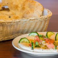 Hummus With Qullaba · Served with warm pita bread. Hummus dish topped with qullaba (Small pieces of lamb).