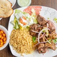 Lamb Kabob · Chunks of tender lamb, marinated in special spices and garlic, broiled on skewers over charc...