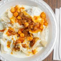Mantu · Homemade pastry shells filled with onions and beef served on yogurt and topped with carrots,...