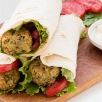 Broken Falafel Pita Wrap · Our creamy, classic hummus with our housemade, crispy fried falafel, served in a soft pita w...