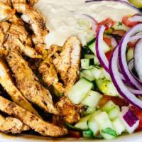 Chicken Shawarma Bowl · Thinly sliced, marinated and spit-roasted chicken, served on a bed of fresh greens, tangy fe...