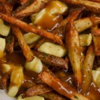 Poutine · Fries layered with five cheese blend, beef gravy and green onions.