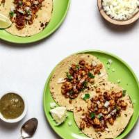 Vegan Chorizo Tacos · Two tacos with vegan chorizo, fire roasted tomatoes, beer braised onions, vegan beer cheese,...