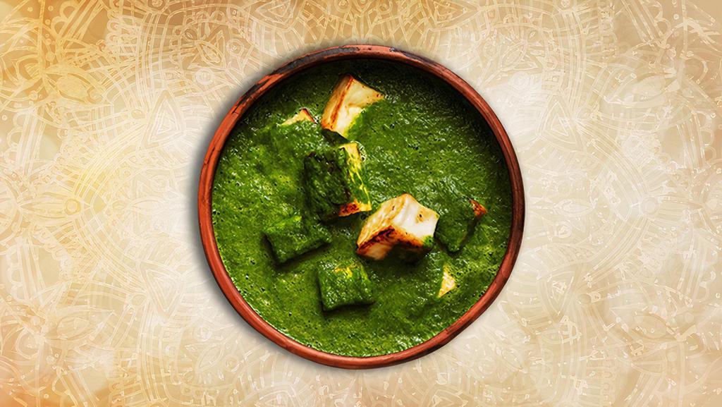 Cottage Cheese & Spinach · Indian cottage cheese cubes in a mild, spiced smooth spinach sauce and creamy dish is made with fresh spinach leaves, paneer (firm cottage cheese), onions, tomatoes, herbs, and spices. Served with a side of our aromatic basmati rice.