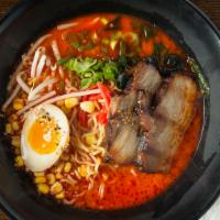 Spicy Tonkotsu Ramen · Soy glazed egg, pork belly, chili sauce, and standard toppings.