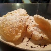 Sopaipillas 4Ct · A Fried Pastry Topped with Powdered Sugar, Cinnamon, and Honey