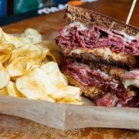 Reuben · Corned beef, sauerkraut, Swiss cheese, Thousand Island, on grilled rye. Served with kettle c...