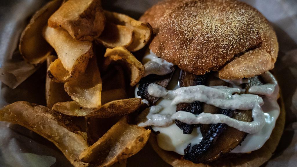 Mushroom Swiss Burger · 8 oz all-beef patty, sautéed mushrooms, Swiss cheese, Caesar dressing, served on a Kaiser bun. Served with French fries.